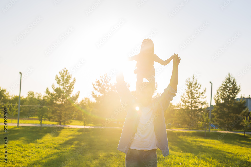 Fatherhood, family and children concept - Father and daughter having fun and playing in nature. Fatherhood, family and children concept - Father and daughter having fun and playing in nature.