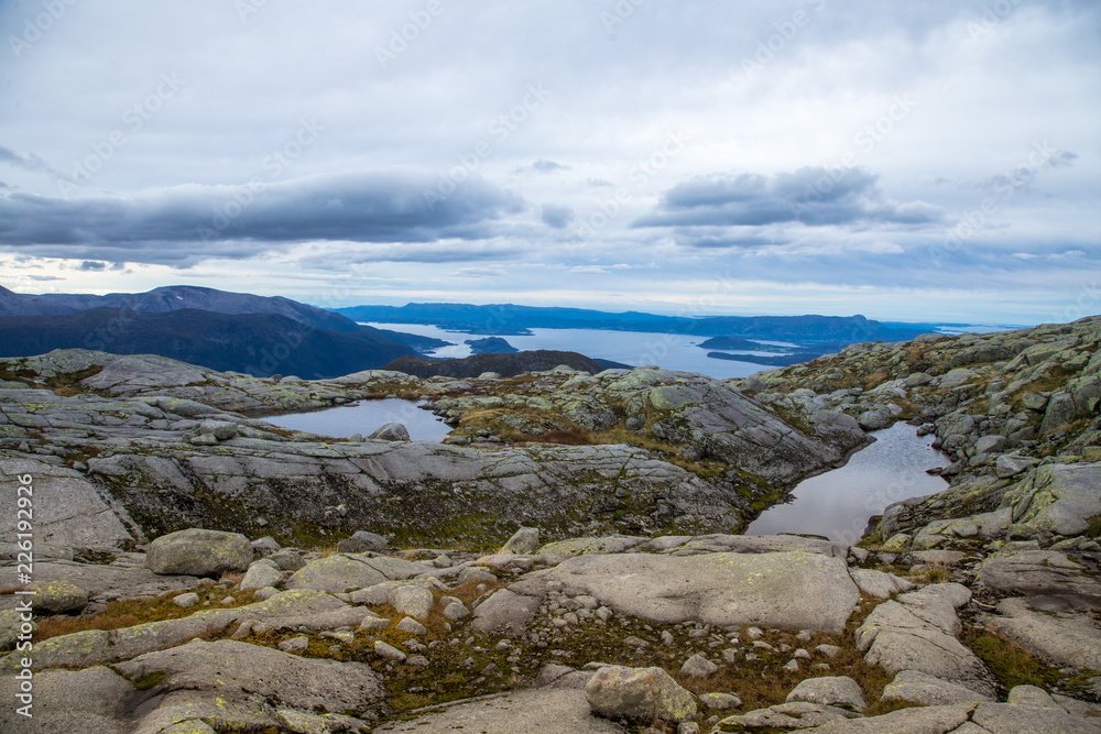 A beautiful autumn mountain landscape with a small lake. Natural scenery in Norwegian mountains. Small water pond in mountains.