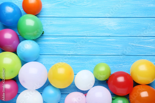 Colorful balloons on blue wooden table