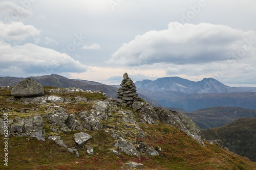 A beautiful autumn landscape in Folgefonna National Park in Norway during a hike in windy  rainy weather. Mountains in Scandinavia. Autumn scenery in wilderness.