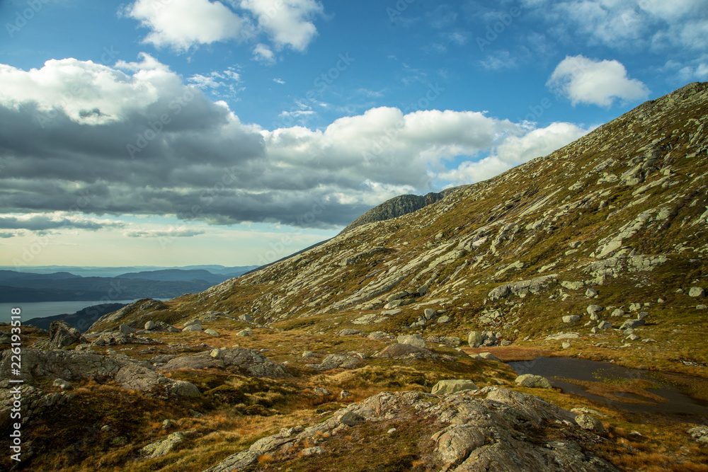 A beautiful autumn landscape in Folgefonna National Park in Norway during a hike in windy, rainy weather. Mountains in Scandinavia. Autumn scenery in wilderness.