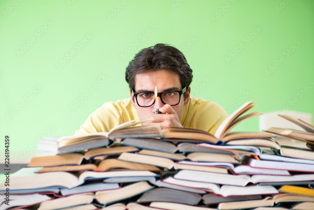 Student with too many books to read before exam Student with too many books to read before exam