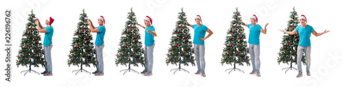 Young man decorating christmas tree isolated on white