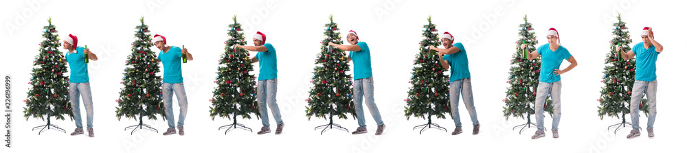 Young man decorating christmas tree isolated on white Young man decorating christmas tree isolated on white
