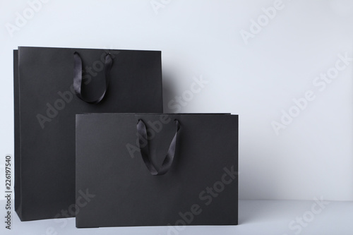 Black shopping bags on grey background