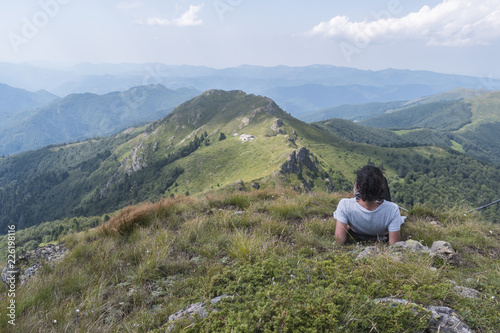 Beautiful girl in the mountains. An incredible view of the Troyan Balkan. The mountain captivates with its beauty, fresh air, a sense of infinity, coziness and tranquility.