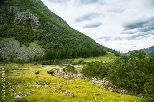 A beautiful green mountain valley near Rosendal in Norway. Autumn landscape in Folgefonna national park. Overcast day. photo