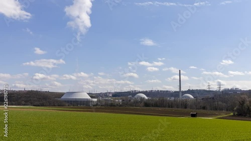 Time lapse shot of the nuclear power plant Neckarwestheim, Germany. Wide angle shot including the surrounding agricultural fields and farms.