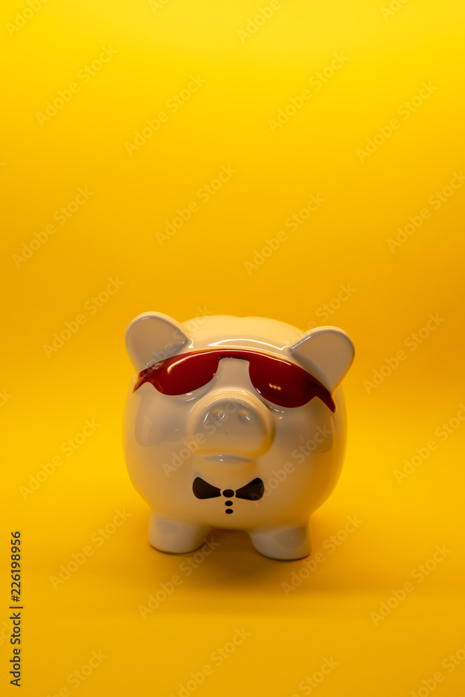 White Pig with glasses money box porcelain on background with copy space White Pig with glasses money box porcelain on background with copy space