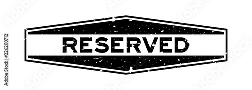 Grunge black reserved word hexagon rubber seal stamp on white background