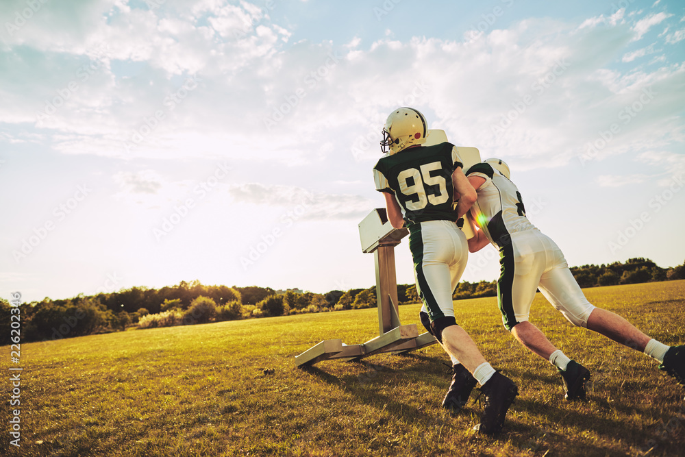 Two American football players doing tackling drills during pract Two American football players doing tackling drills during pract