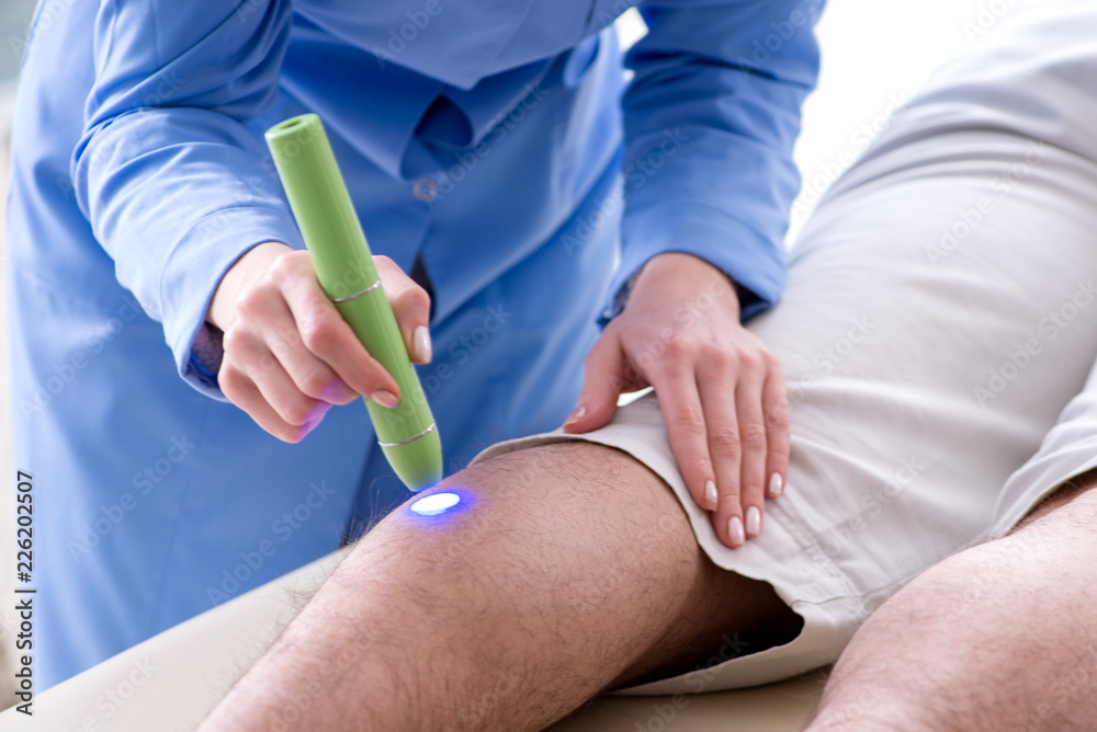 Patient in clinic undergoing laser scar removal Patient in clinic undergoing laser scar removal