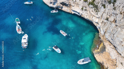 Yachts at the sea in France. Aerial view of luxury floating boat on transparent turquoise water at sunny day. Summer seascape from air. Seascape with motorboat in bay. Travel concept and idea