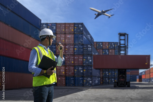 Foreman control loading Containers box to truck for Logistic Import Export Background
