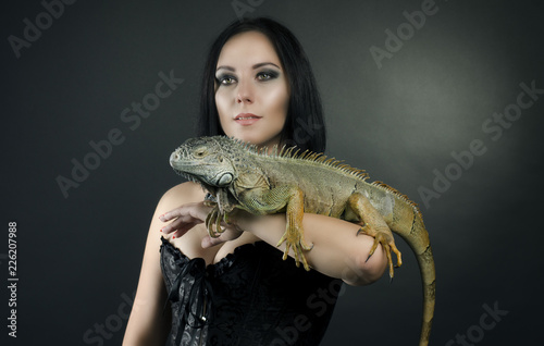 perfect portrait sensual girl and iguana in the studio
