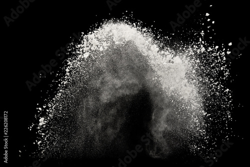 White powder or flour explosion isolated on black background freeze stop motion object design