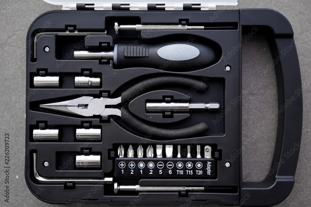 Fototapeta premium Small tool kit with basic tools screw driver tapered nose pliers and spanner for home improvement