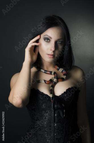 beautiful woman and king snake in the studio
