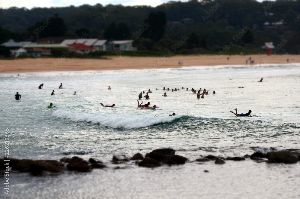 Avoca beach, Australia - Apr 12, 2015. People surfing in the sea. People can enjoy swimming, surfing, sunbathing and relaxing at Avoca beach.
