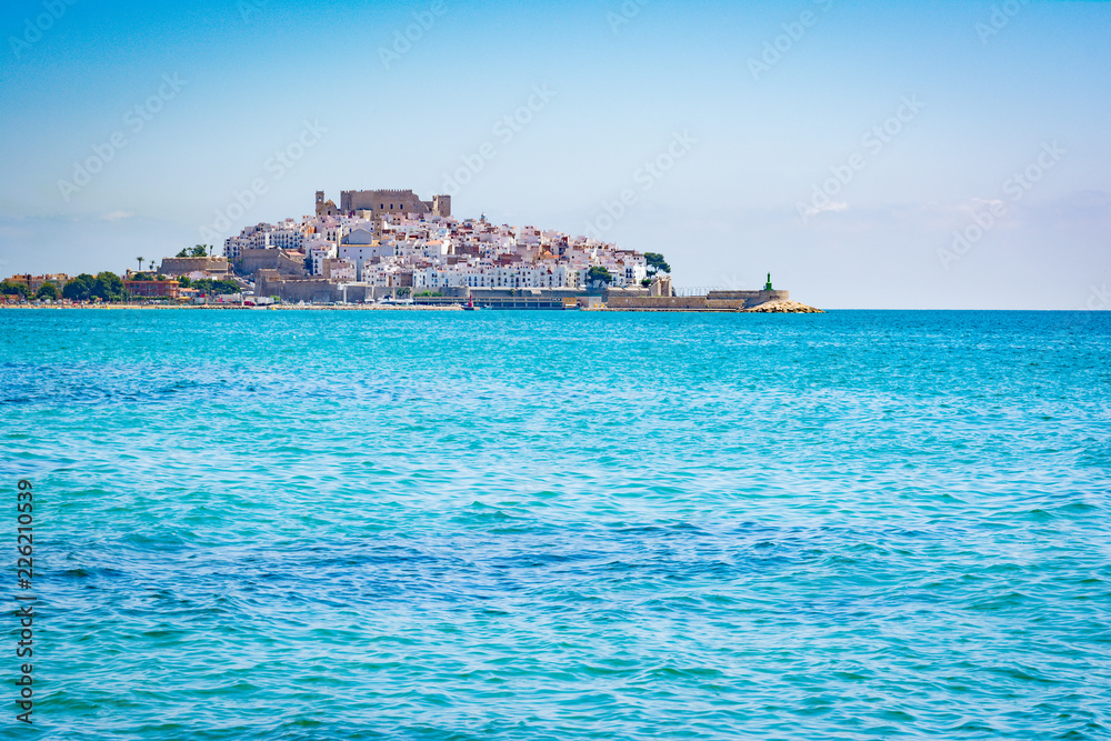 Old town on the sea. The castle of Peniscola, located on Costa del Azahar in the Castellon province of Spain. This popular tourist destination is located on a rocky headland.