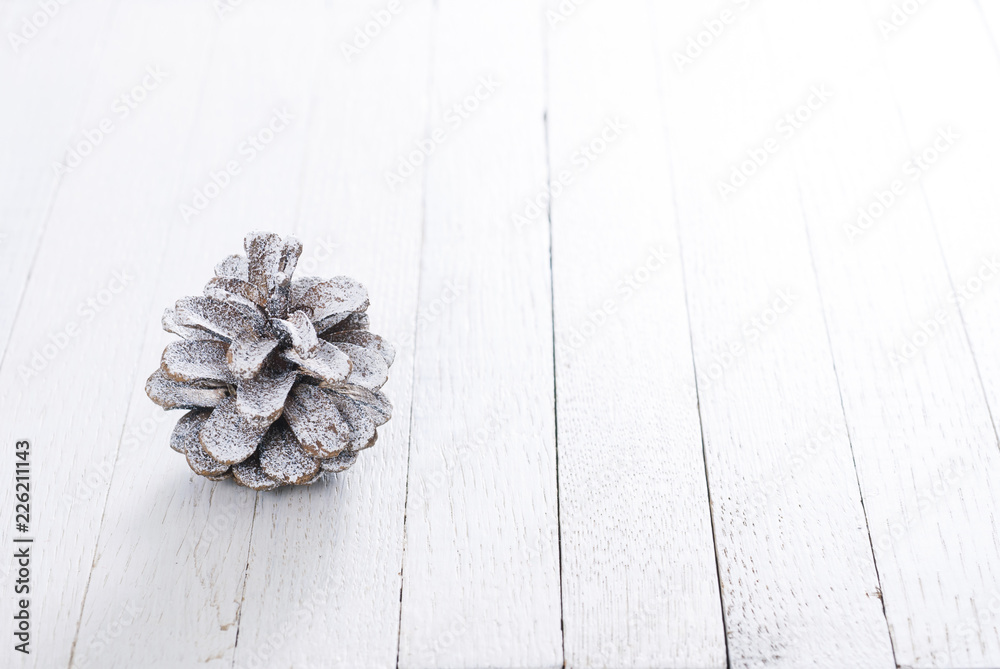 snow painted pine cone on rustic white wood table, Christmas decoration background snow painted pine cone on rustic white wood table, Christmas decoration background