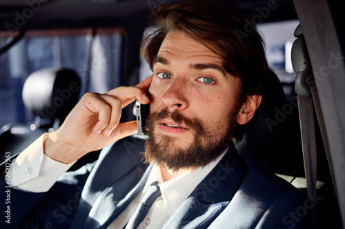 business man talking on the phone in the car