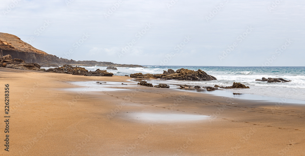 La Solapa, a Virgin Gold-Colored Sandy Beach in Fuerteventura, Canary Islands La Solapa, a Virgin Gold-Colored Sandy Beach in Fuerteventura, Canary Islands