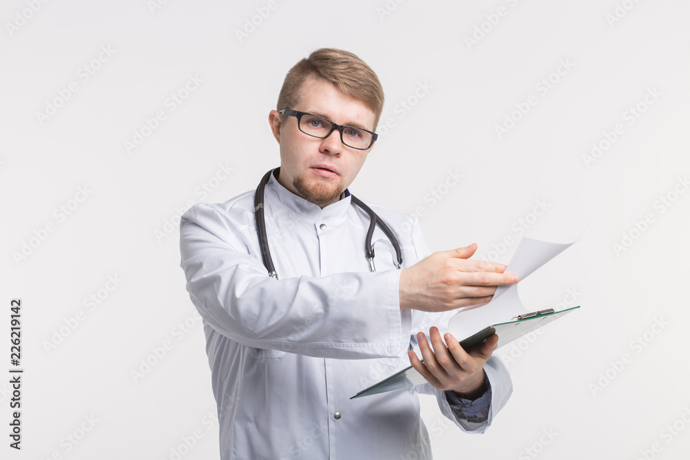 Medicine and health concept - doctor with stethoscope holding document folder on white background Medicine and health concept - doctor with stethoscope holding document folder on white background