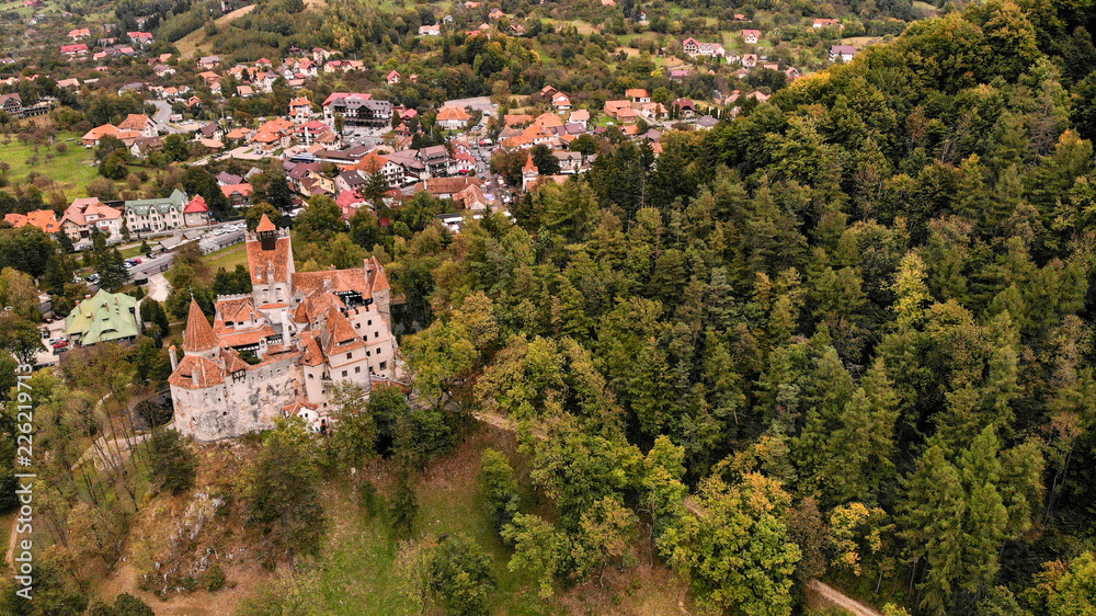 Obraz premium Aerial view of Bran castle in beautiful Transylvania, region of Romania. Cloudy day with dark clouds