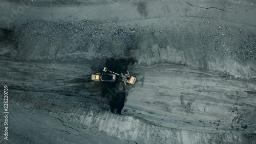 Aerial quarry shot from quadrupter. Industrial vehicles overall plan. photo