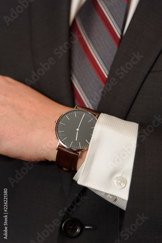 man in suit, tie and wrist watch