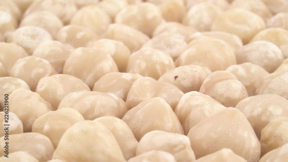 Heap of blanched hazelnuts. Slowly rotating on the turntable. Close up. Macro. Heap of blanched hazelnuts. Slowly rotating on the turntable. Close up. Macro.