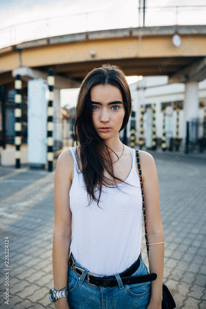 Frightened young woman dressed in white top