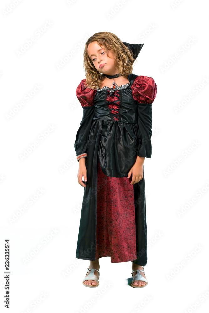 A full-length shot of a Kid dressed as a vampire at halloween holidays unhappy and frustrated with something. Negative facial expression isolated on white