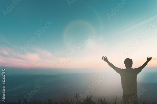 Happy man rise hand on morning view. Christian inspire praise God on good friday background. Now one man self confidence on peak open arms enjoying nature the sun concept world wisdom fun hope. photo