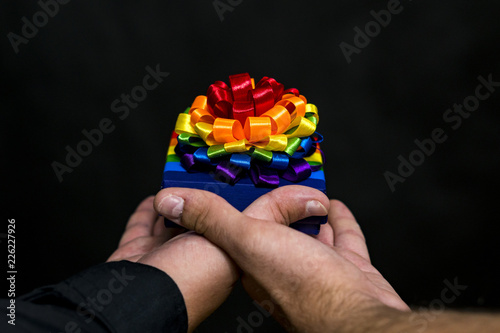 LGBT community. Festive gift in hands. Close-up.