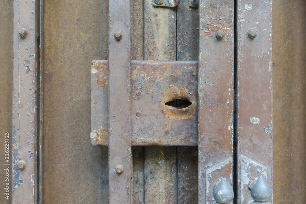 Closeup no lock rusty metal foldable door