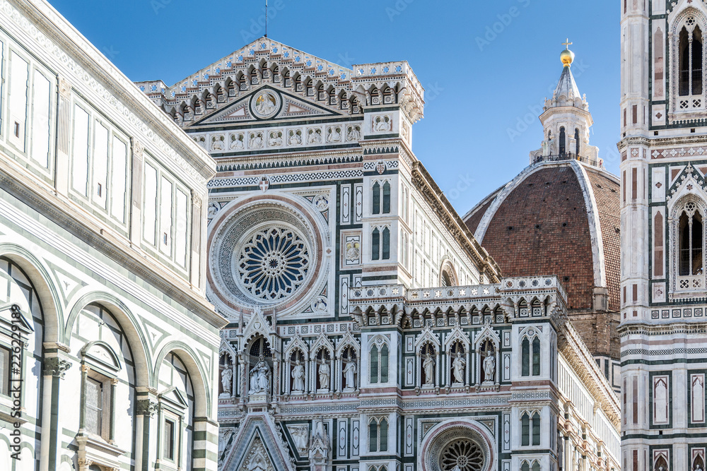 Details on the facade of the famous Florence Cathedral and the Duomo in Florence, Italy in a bright sunny day.