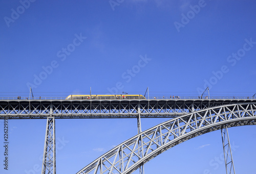 Train rides on Dom Luis I Bridge over the river Douro, Porto, Portugal.