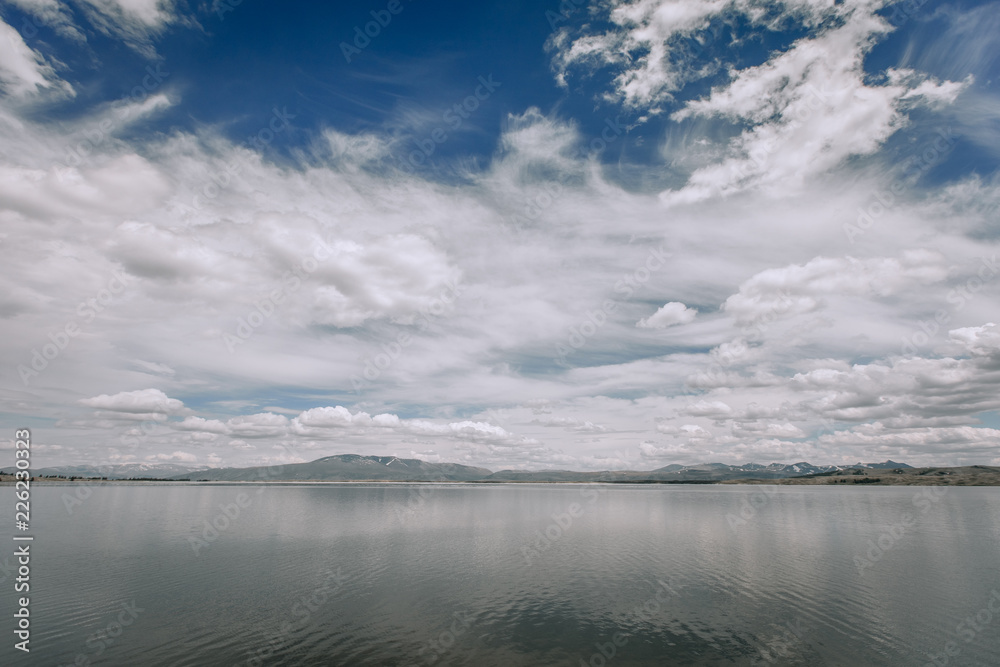 Mountain Lake . Blue sky background with clouds