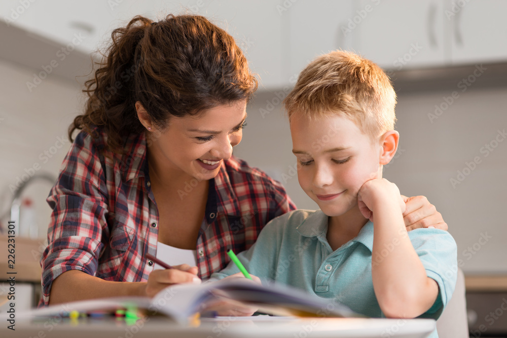 Little boy sketching with his mother at home Little boy sketching with his mother at home
