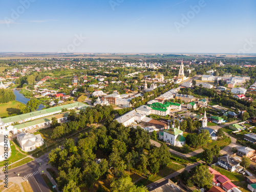 Beautiful panoramic view of Suzdal in summer at sunrise. Resurrection Church on the market square in Suzdal. Suzdal is a famous tourist attraction and part of the Golden Ring of Russia © miklyxa