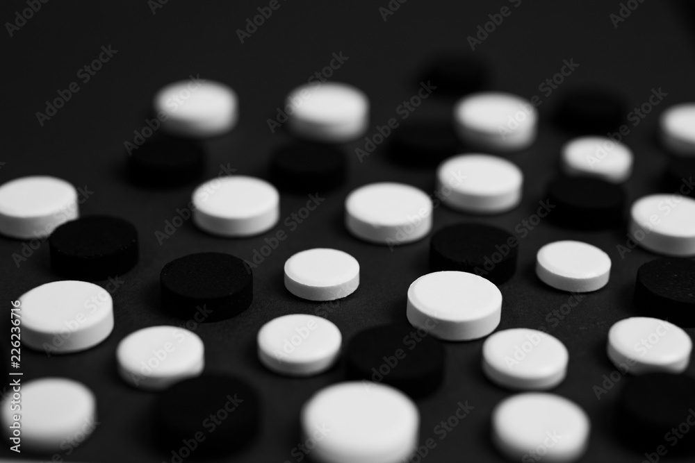 Assortment of various colourful pills on black and white background. Assortment of various colourful pills on black and white background.