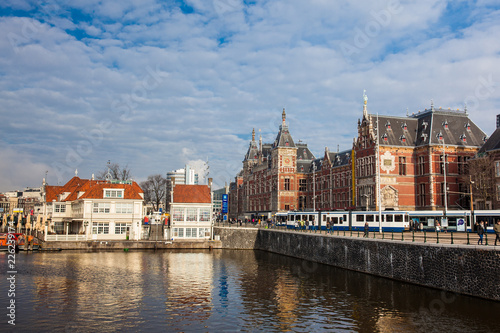 Canals, central railway station and tram at the Old Central district of Amsterdam © anamejia18