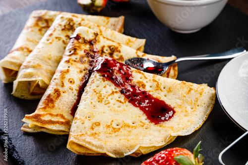 Crepes with strawberries and jam