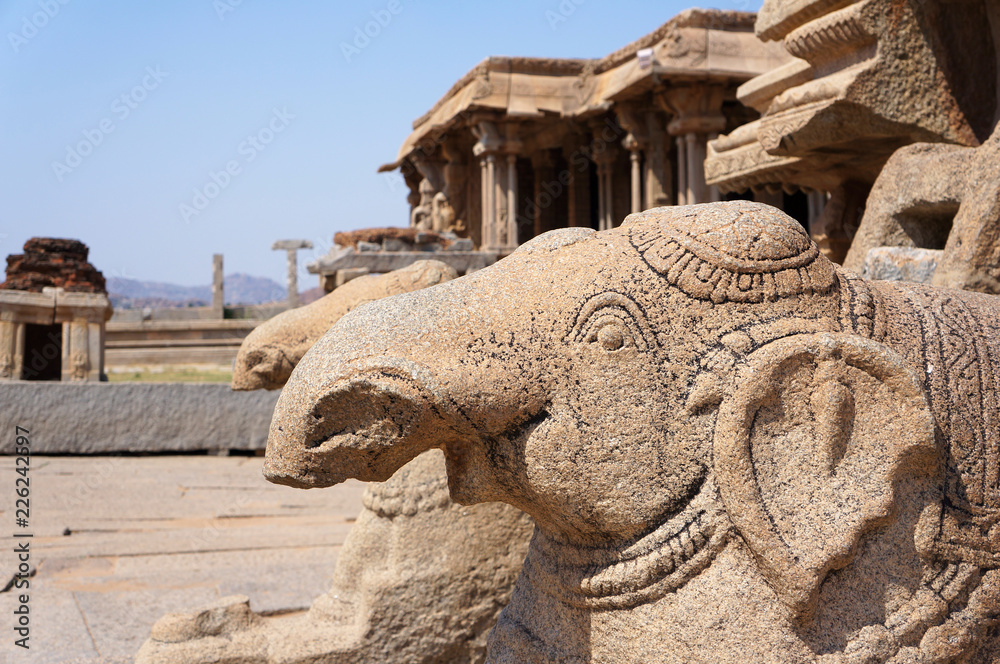 Statues of stone elephants at the chariot in the ancient temple Vittala, India, Hampi