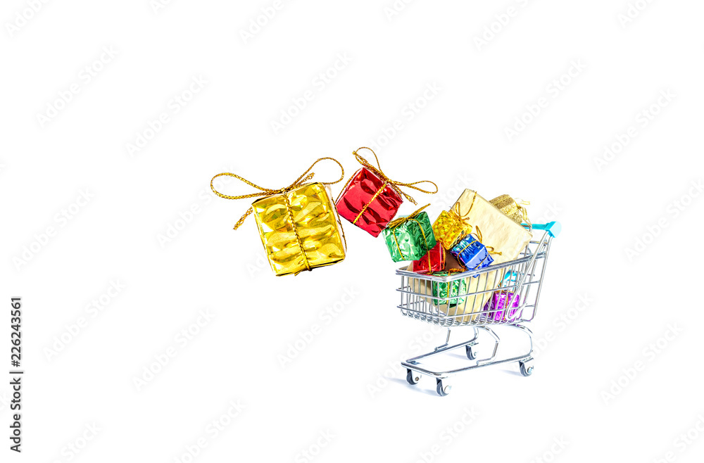 Multicolored gift boxes with beautiful golden bows fall into a gift-filled shopping cart isolated on a white background