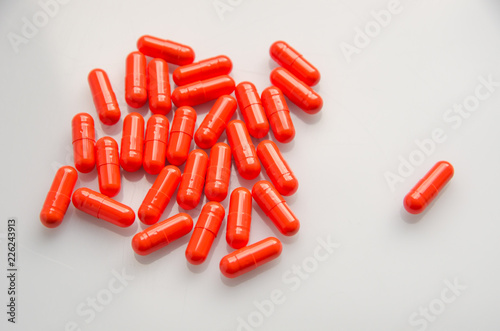 red capsules scattered on the table