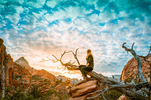 Blond girl with green shirt overlooking a landscape