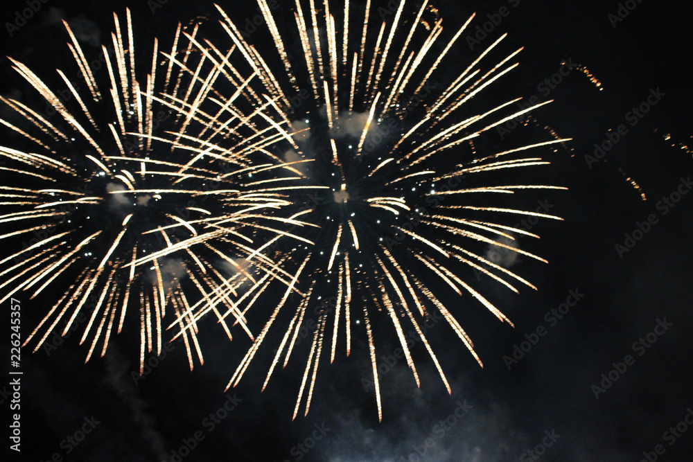 Fireworks. Salute. Sky background Amazing agony of bright yellow shiny lights in the night sky during the New Year and Christmas holidays. Fireworks. Salute. Sky background Amazing agony of bright yellow shiny lights in the night sky during the New Year and Christmas holidays.